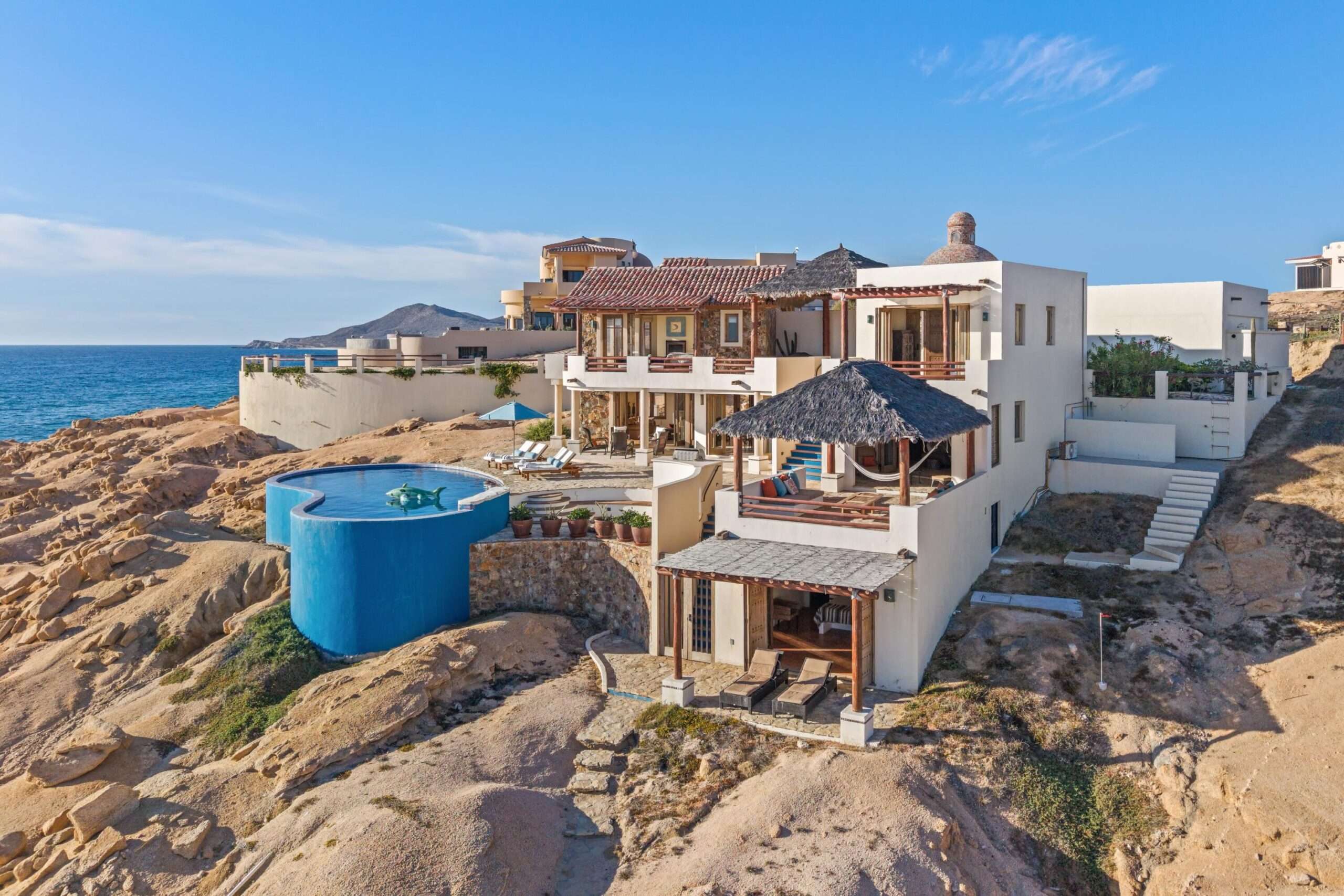 Four Seasons Cabo Rancholasmargaritas Casa Playa Escondida - Oceanfront Luxury in Baja California SurPerched dramatically on the rocks above the Pacific Ocean, Casa Playa Escondida is a rare oceanfront retreat set along a secluded, pristine stretch of beach. Located within the exclusive off-grid gated community of Rancho Las Margaritas, this one-of-a-kind property offers privacy, tranquility, and breathtaking natural beauty--just a 20-minute drive to the dining and shopping of Cabo San Lucas, 40 minutes from Los Cabos International Airport, and approximately 30 minutes south of Cerritos and Todos Santos.The residence features three spacious ensuite bedrooms, each privately situated yet connected by terraces, pathways, and shared gathering spaces. A dedicated media room offers flexibility as a fourth bedroom or additional guest suite.Expansive terraces and multiple lounging areas provide a variety of vantage points to take in the surrounding landscape, from the rugged coastline to the endless Pacific horizon.The gourmet kitchen is equipped with high-end appliances and designed for both functionality and style. A warm and inviting living and dining area, anchored by a striking fireplace, creates the perfect space for entertaining or relaxing with family and friends. The home is offered fully furnished with includes modern off-grid conveniences such as solar power.Outdoor living is equally exceptional, featuring a swimming pool, firepit, grilling area, and multiple seating spaces--ideal for enjoying the serene coastal setting for sale