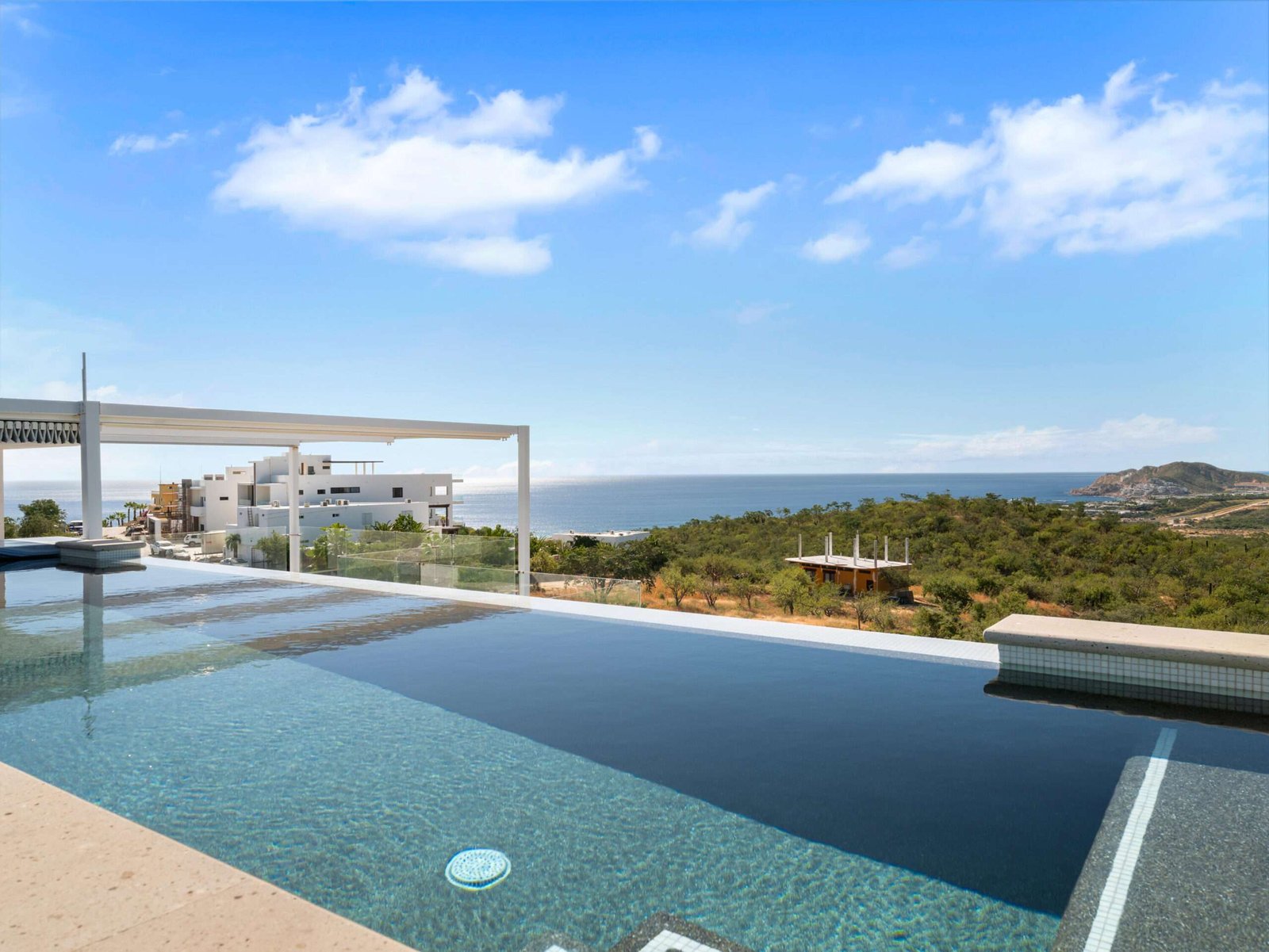 Four Seasons Cabo Rancholasmargaritas Casa Playa Escondida - Oceanfront Luxury in Baja California SurPerched dramatically on the rocks above the Pacific Ocean, Casa Playa Escondida is a rare oceanfront retreat set along a secluded, pristine stretch of beach. Located within the exclusive off-grid gated community of Rancho Las Margaritas, this one-of-a-kind property offers privacy, tranquility, and breathtaking natural beauty--just a 20-minute drive to the dining and shopping of Cabo San Lucas, 40 minutes from Los Cabos International Airport, and approximately 30 minutes south of Cerritos and Todos Santos.The residence features three spacious ensuite bedrooms, each privately situated yet connected by terraces, pathways, and shared gathering spaces. A dedicated media room offers flexibility as a fourth bedroom or additional guest suite.Expansive terraces and multiple lounging areas provide a variety of vantage points to take in the surrounding landscape, from the rugged coastline to the endless Pacific horizon.The gourmet kitchen is equipped with high-end appliances and designed for both functionality and style. A warm and inviting living and dining area, anchored by a striking fireplace, creates the perfect space for entertaining or relaxing with family and friends. The home is offered fully furnished with includes modern off-grid conveniences such as solar power.Outdoor living is equally exceptional, featuring a swimming pool, firepit, grilling area, and multiple seating spaces--ideal for enjoying the serene coastal setting for sale