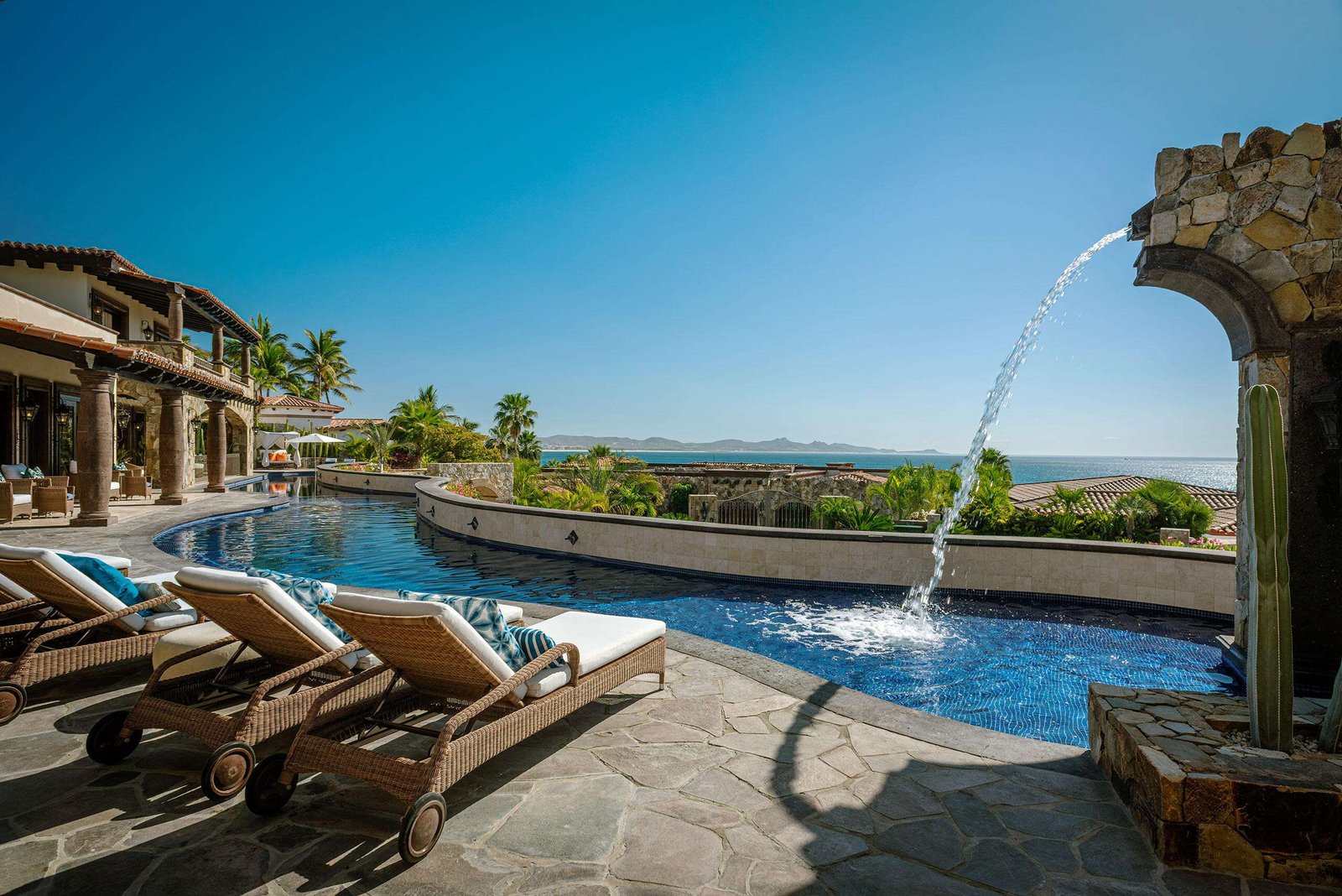 Four Seasons Cabo Palmilla Cove Villa Encanto, located at Palmilla Cove 5, offers a traditional design with hints of Old Hacienda Architecture, captured in the stone façade and archways throughout. The home offers a calming neutral palette, comfort, and practicality.A bit of wow comes into play with the 100' plus sprawling pool. Flowing the length of the home, the pool features a centrally located sunken spa, wet shelf, spitter fountains and cascading waterfall. Multi outdoor gathering spots are scattered throughout, offering places for lounging or leisurely long lunches, and even sneaking away to a quiet spot.The approach with the interior was to capture the ocean – Villa Encanto, Palmilla Cove 5, San Jose Corridor, San Jose Corridor, BS
